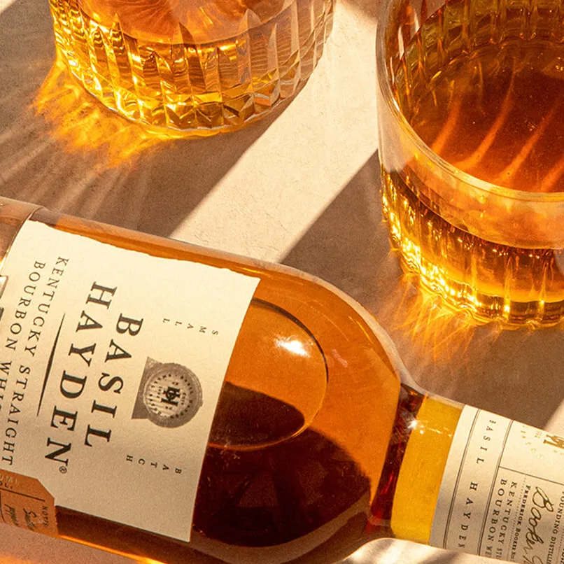 Basil Hayden pouring bourbon in glass