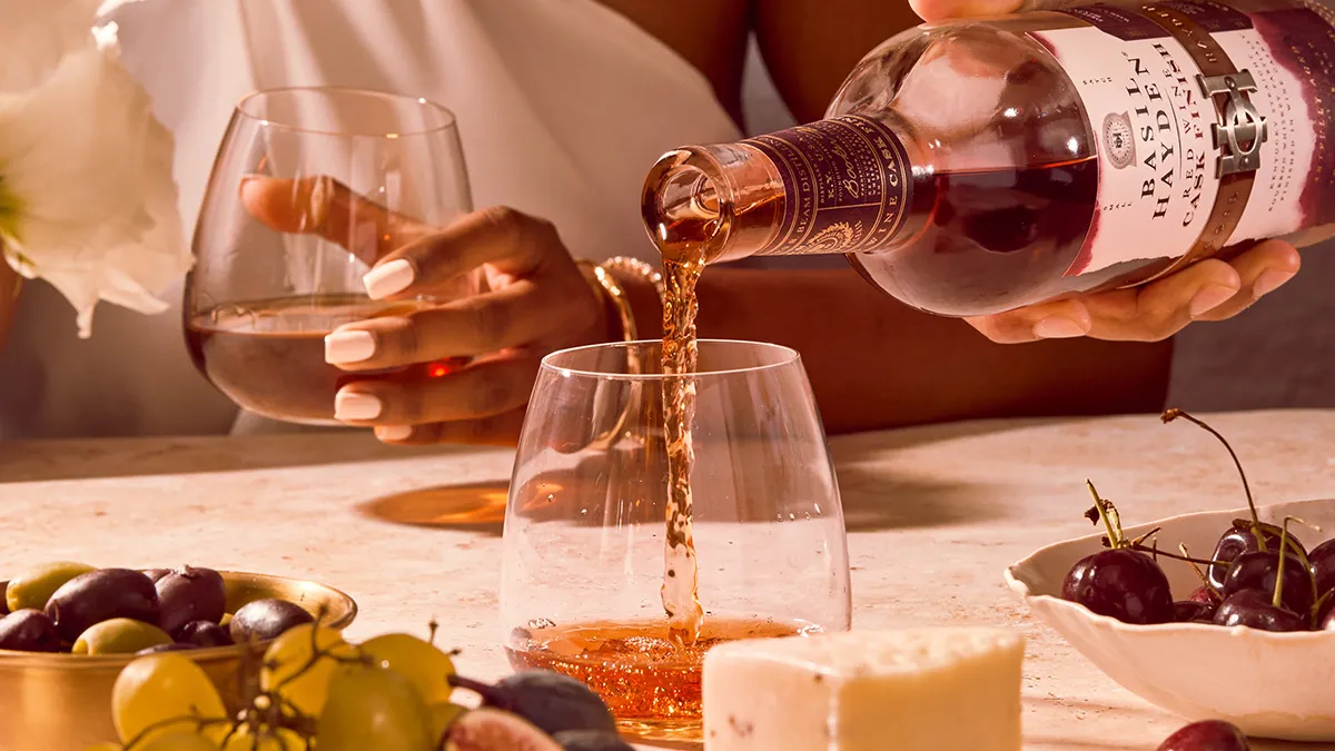 Pouring some Basil Hayden® Red Wine Cask Finish in a glass