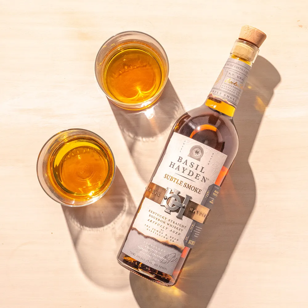 Basil Hayden® Subtle Smoke Bourbon bottle and tow glasses ready to drink