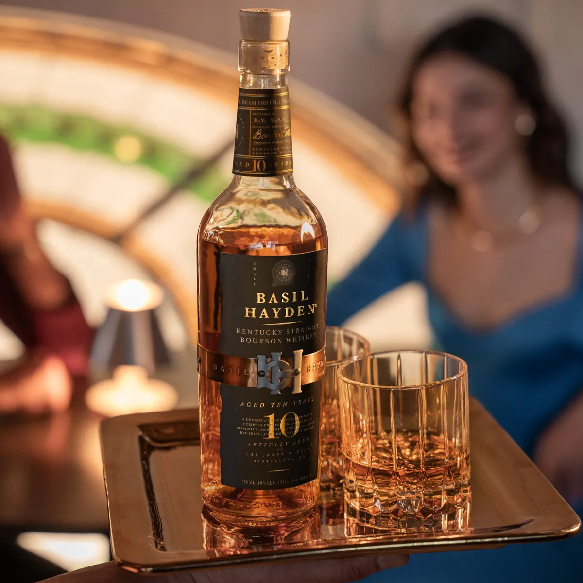 Basil Hayden® 10 Year Old Bourbon bottle to be served at a table with a couple waiting